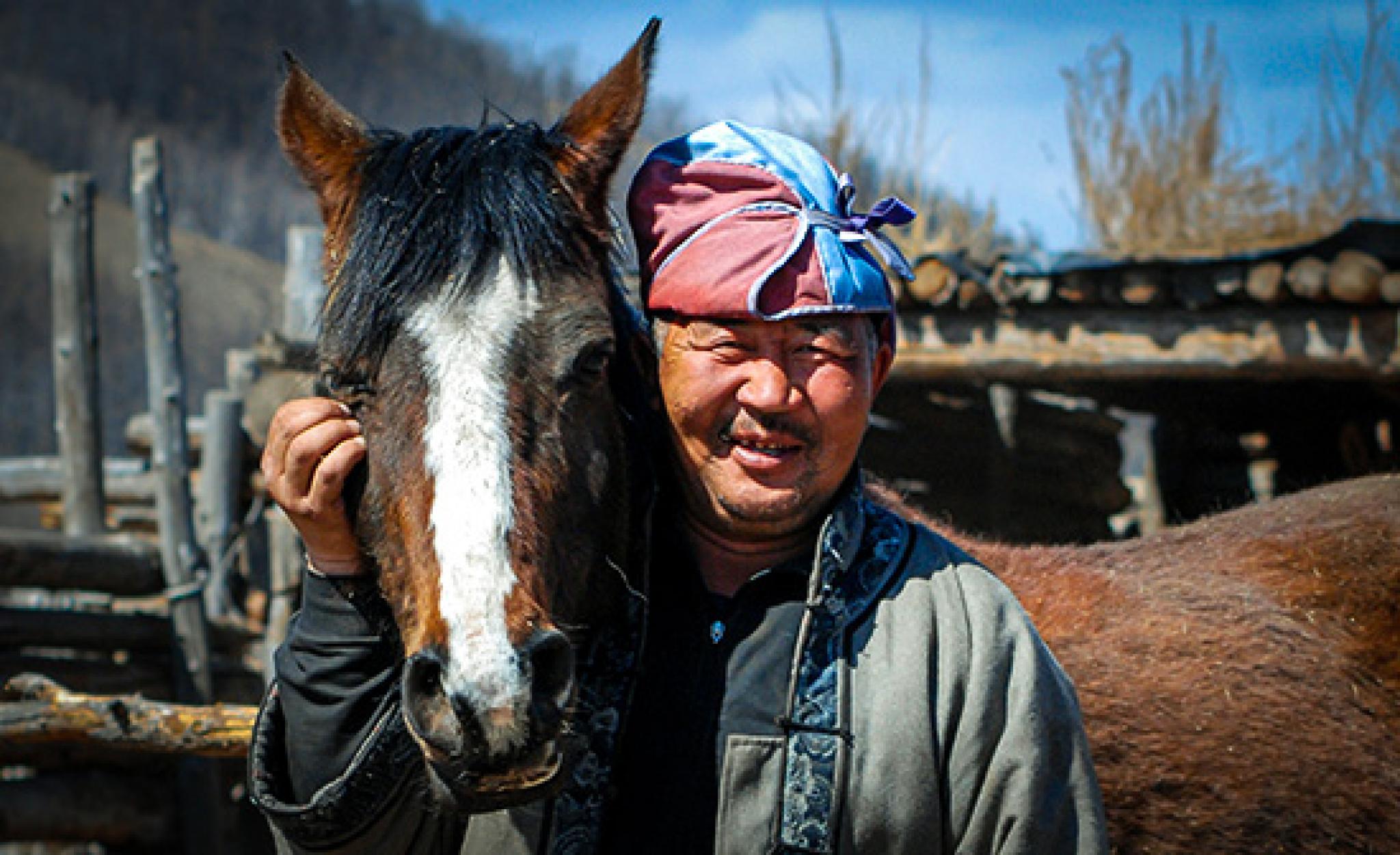 A Mongolian man and her horse, ANU Mongolia Institute.